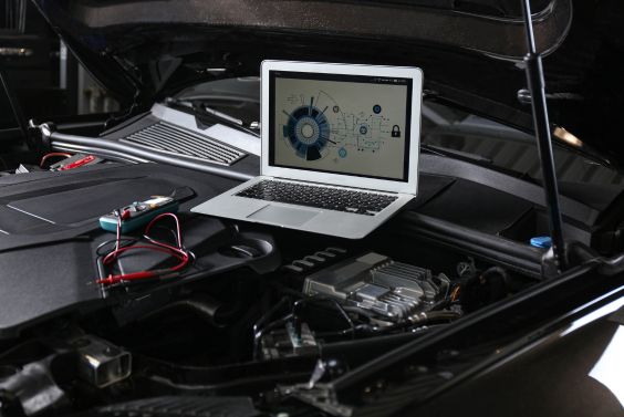 Laptop with Diagram on Auto Engine. Modern Car Diagnostic